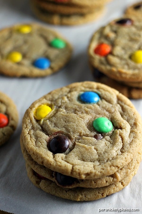 stack of brown sugar M&M cookies on parchment paper This Brown Sugar M&M Cookie recipe is a fun twist on the traditional sugar cookie that will definitely satisfy your sweet tooth. | Persnickety Plates
