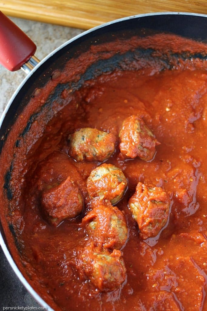 Easy Italian Chicken Meatball Subs smothered in a homemade marinara sauce and topped with provolone and mozzarella cheese! | Persnickety Plates