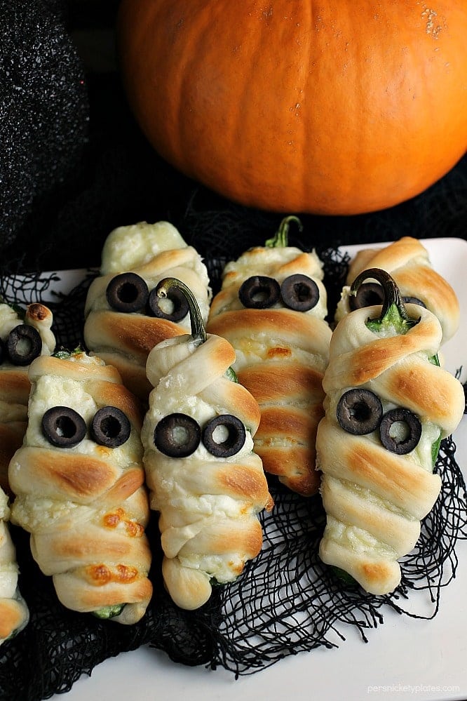 Jalapeno Popper Mummies wrapped in Rhodes bread "bandages" make a spicy and spooky treat for your next Halloween party! | Persnickety Plates