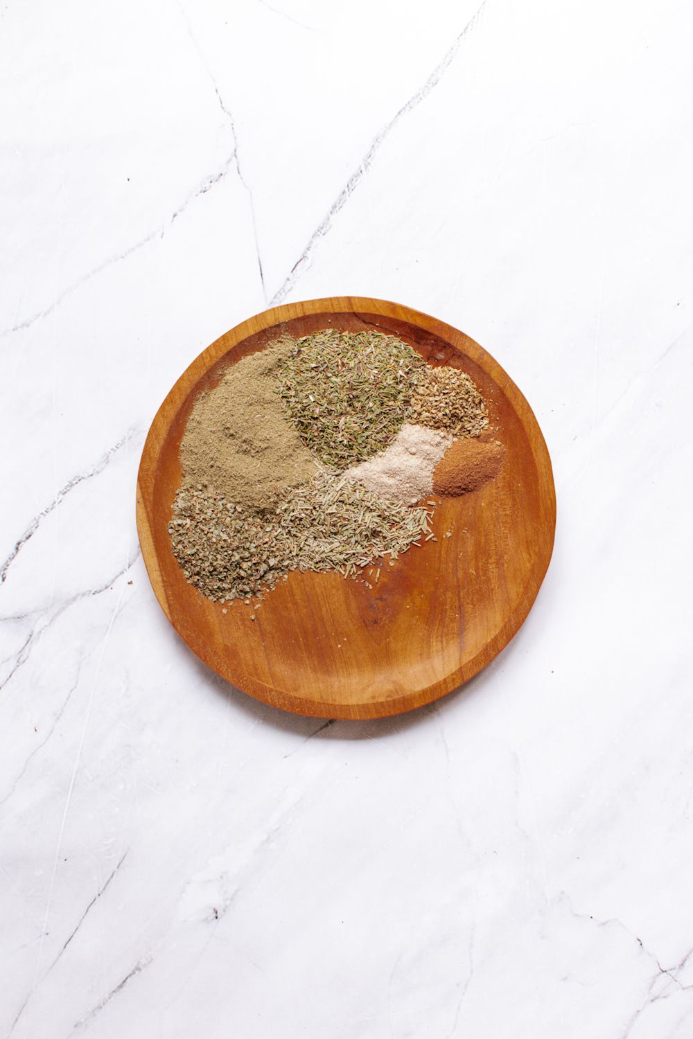 Ingredients for poultry seasoning including sage, rosemary, thyme, marjoram, and pepper.