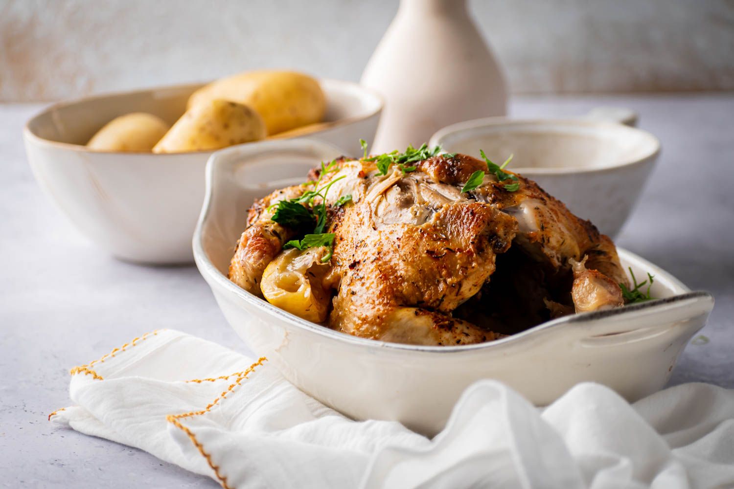 Homemade rotisserie chicken cooked in the slow cooker with lemon, garlic, and spices.