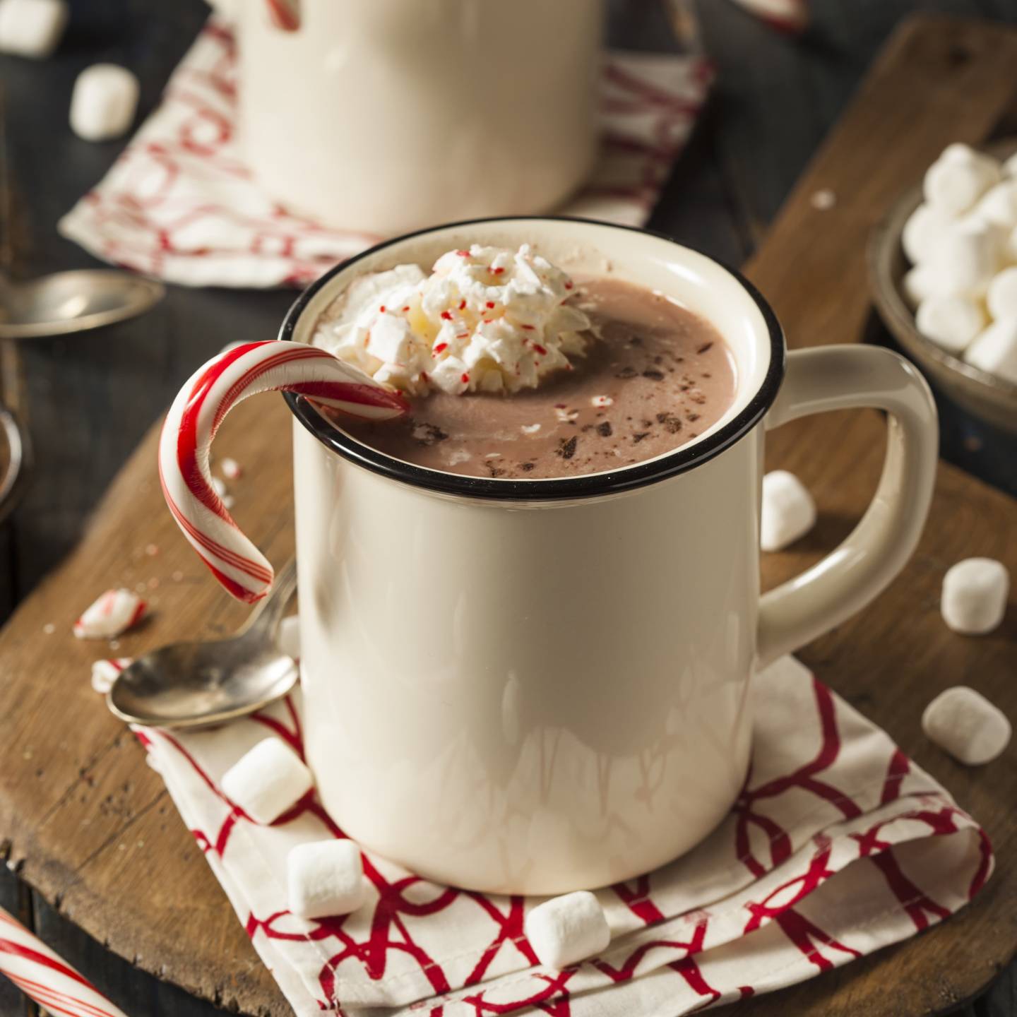 Healthy Peppermint Mocha in a mug with a candy cane and whipped cream.