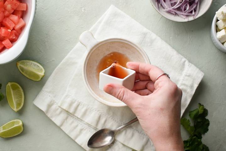 Lime vinaigrette being made with honey for a watermelon salad.