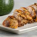 Grilled Mediterranean Pork Tenderloin with a spice rub on a white plate.