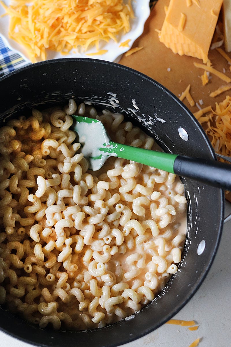 Homemade Baked Macaroni and Cheese is a delicious, super rich, five cheese baked mac and cheese recipe. This copycat steakhouse recipe is fancy enough to serve to guests for holidays, but so delicious, you'll want to make this easy baked mac and cheese recipe every day! www.persnicketyplates.com pot of noodles and cheese