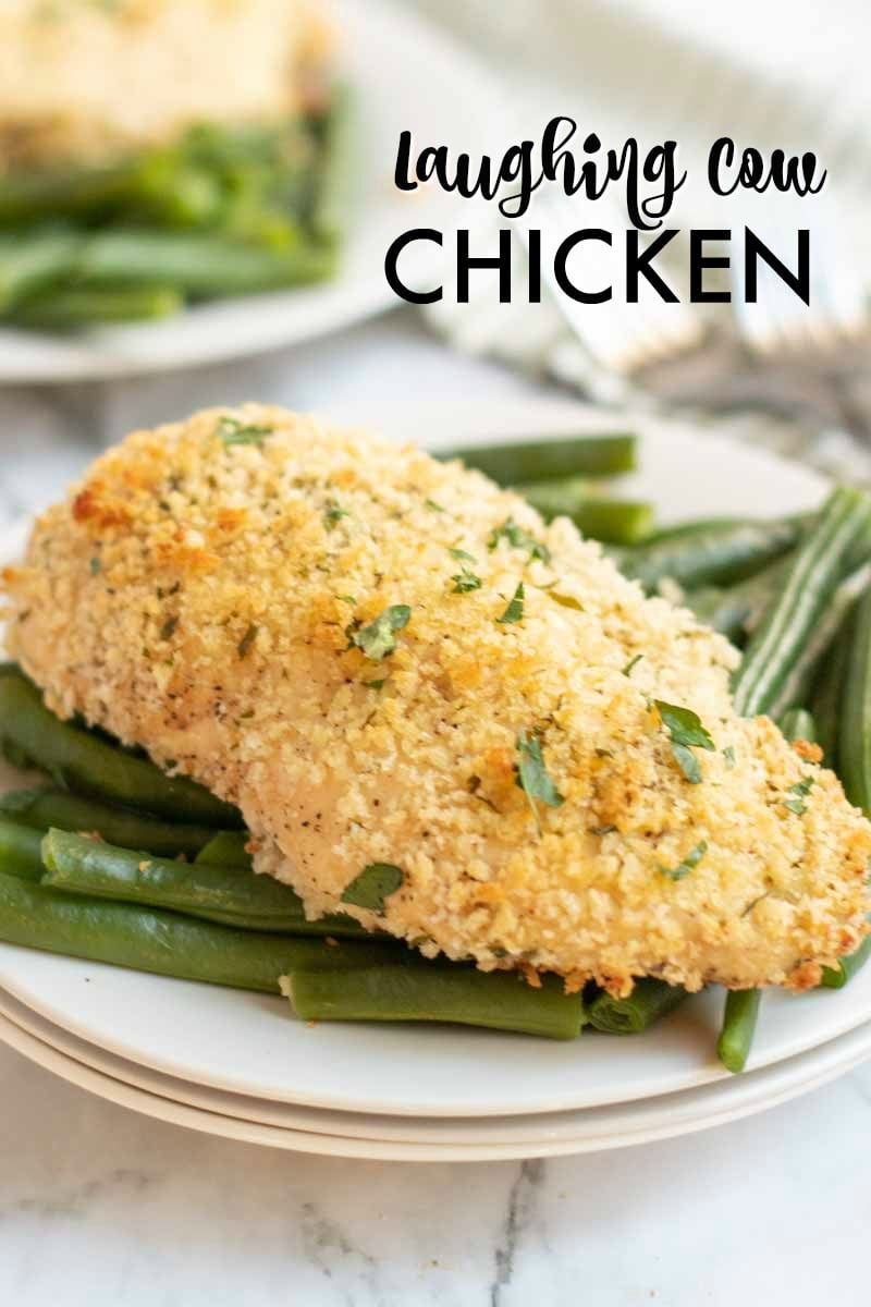 Baked Laughing Cow Chicken on a bed of green beans stacked on three white plates Laughing Cow Chicken is a lightened up version of a stuffed chicken breast. This super easy, 5 ingredient dinner will please your picky eaters and wow your foodies. | www.persnicketyplates.com