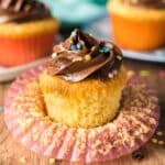 a yellow cupcake sitting in a cupcake wrapper.