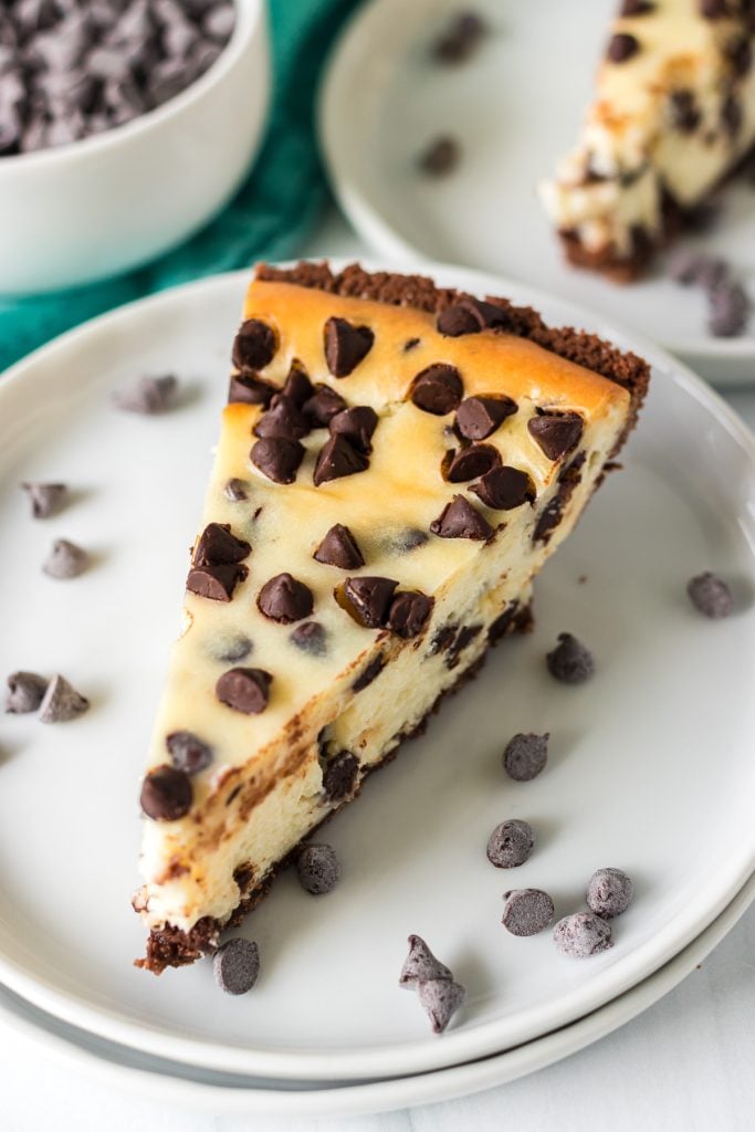 slice of chocolate chip cheesecake on a white plate.