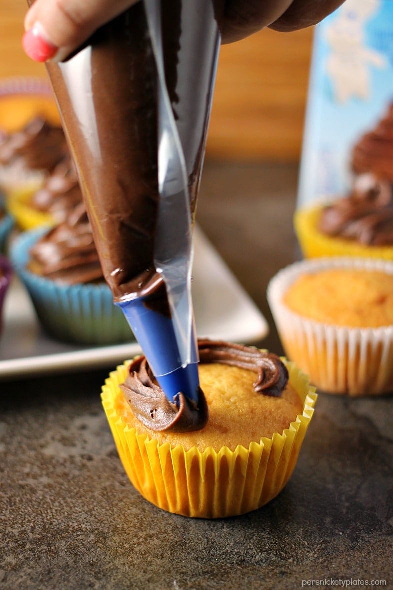 Cheesecake Filled Cupcakes are super simple starting with a cake mix but filled with chocolate chip cheesecake mixture in the centers! | www.persnicketyplates.com