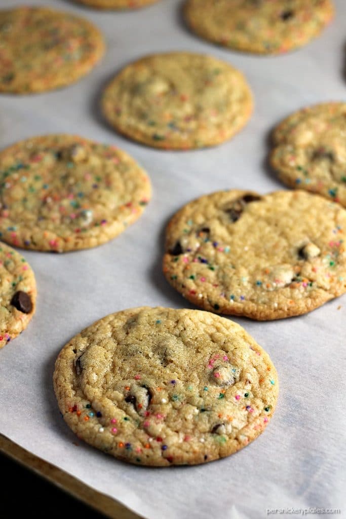 These Perfect Party Cookies start with a cake mix and are full of chocolate chips and sprinkles. Mix up the colors to suit whatever type of party you're having! | Persnickety Plates