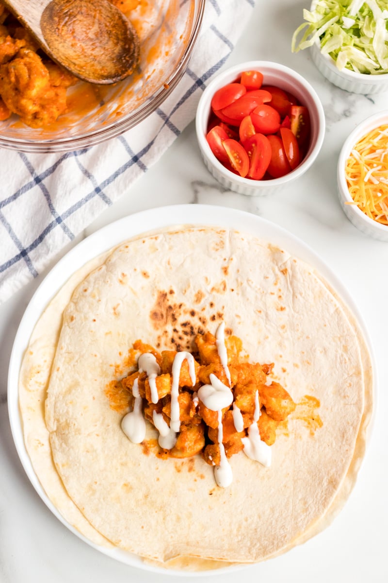 buffalo chicken on a flour tortilla for buffalo ranch chicken wraps
