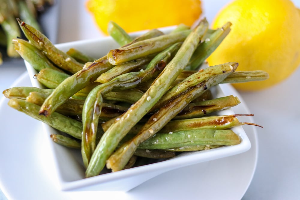 oven roasted garlic green beans in white plate 
