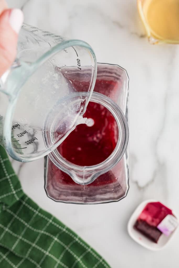 lemonade pouring into a bottle of tea.