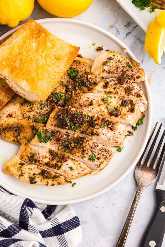 sliced chicken breast on a white plate.