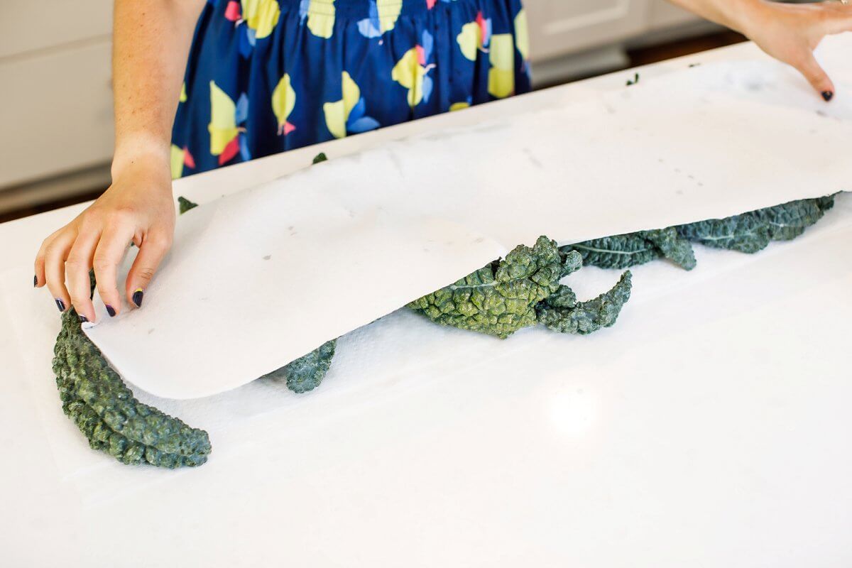 Leafy greens being dried between paper towels