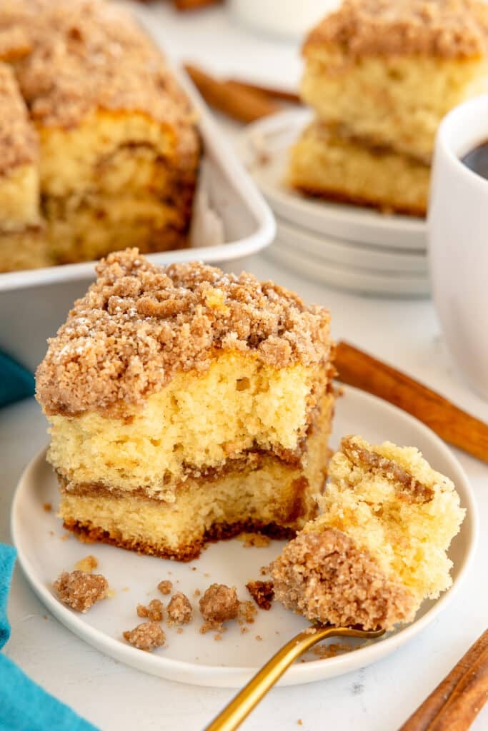 slice of cream cheese coffee cake with a fork taking a bite.