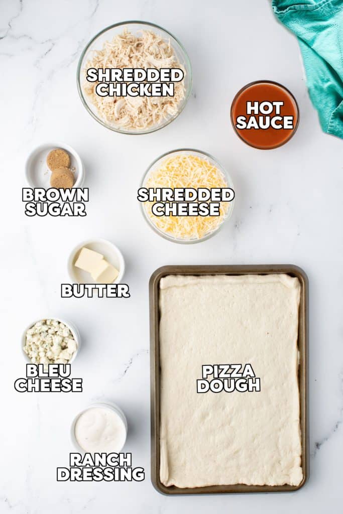 overhead shot of labeled ingredients laid out to make buffalo pizza.