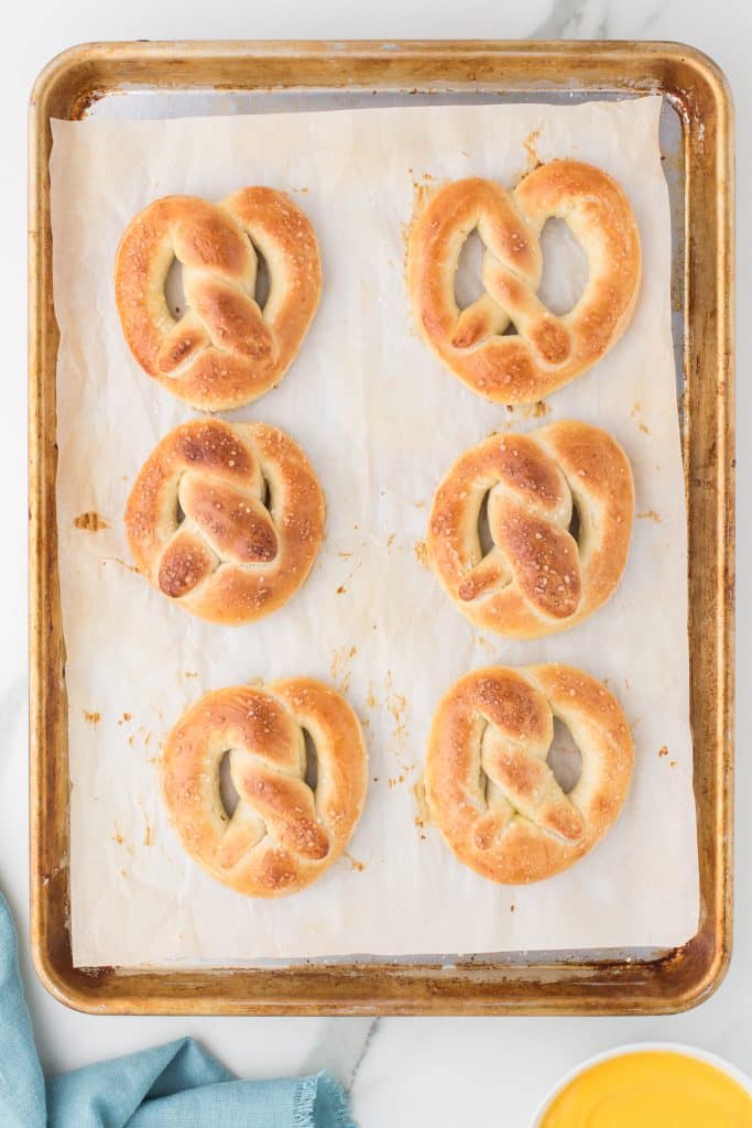 overhead shot of freshly baked pretzels on a baking sheet.