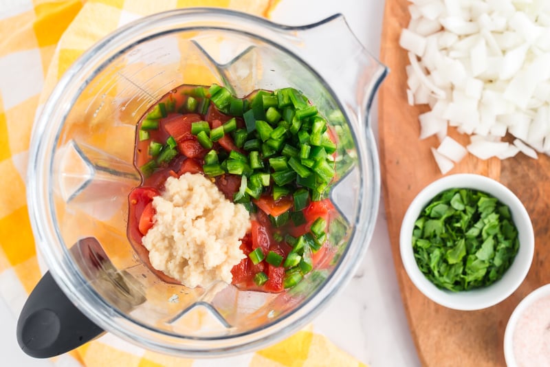 overhead shot of salsa ingredients in blender