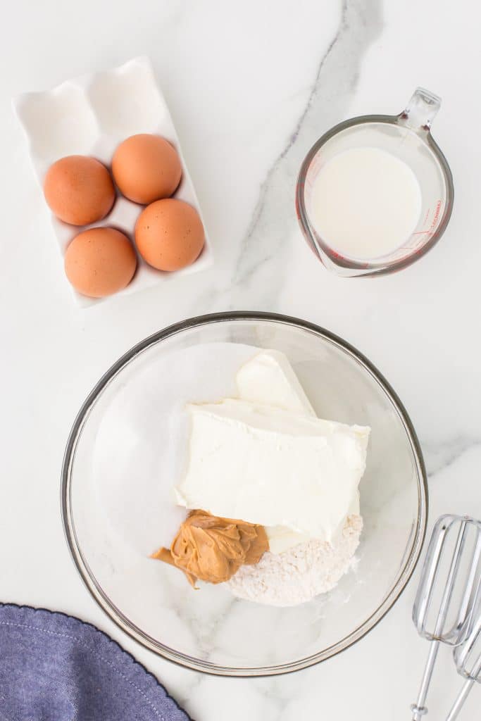 cream cheese and peanut butter in a glass mixing bowl.