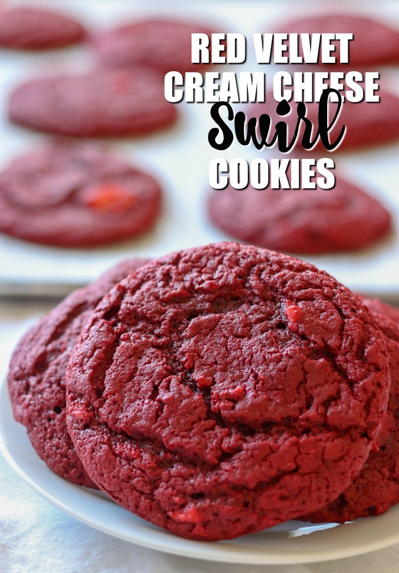 red velvet cream cheese swirl cookies on white plate with cookies in background