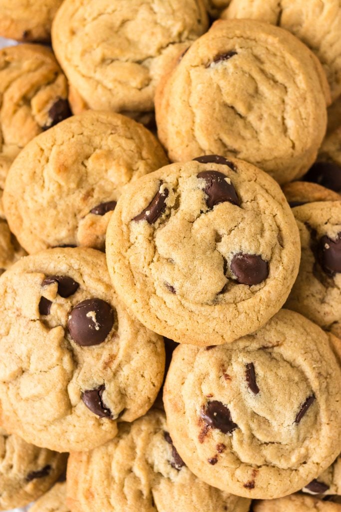 closeup of chocolate chip cookies in a pile.
