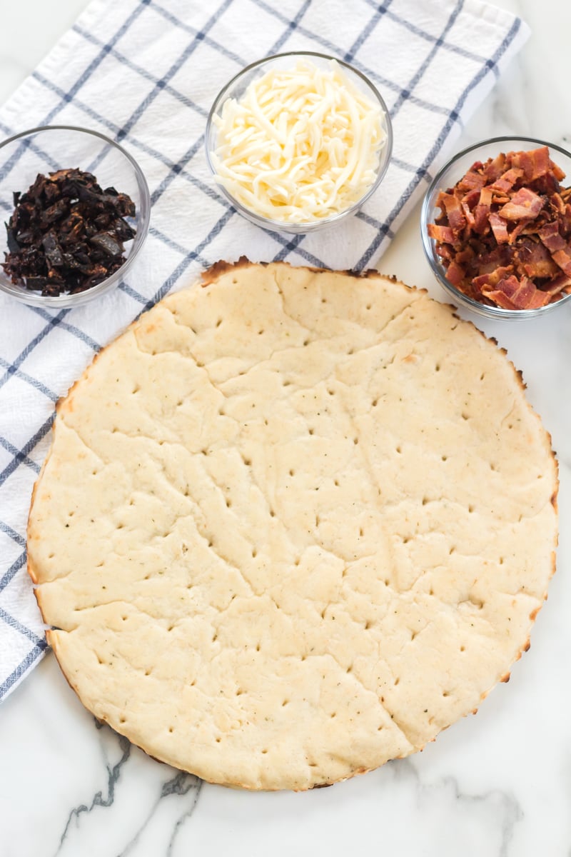 pizza crust, sun dried tomatoes, mozzarella cheese, and chopped bacon for blt pizza 