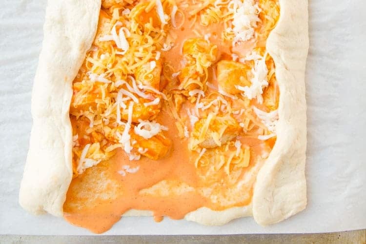 rolling of buffalo chicken bread on dough