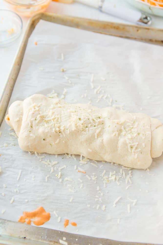 unbaked bread on a baking sheet.