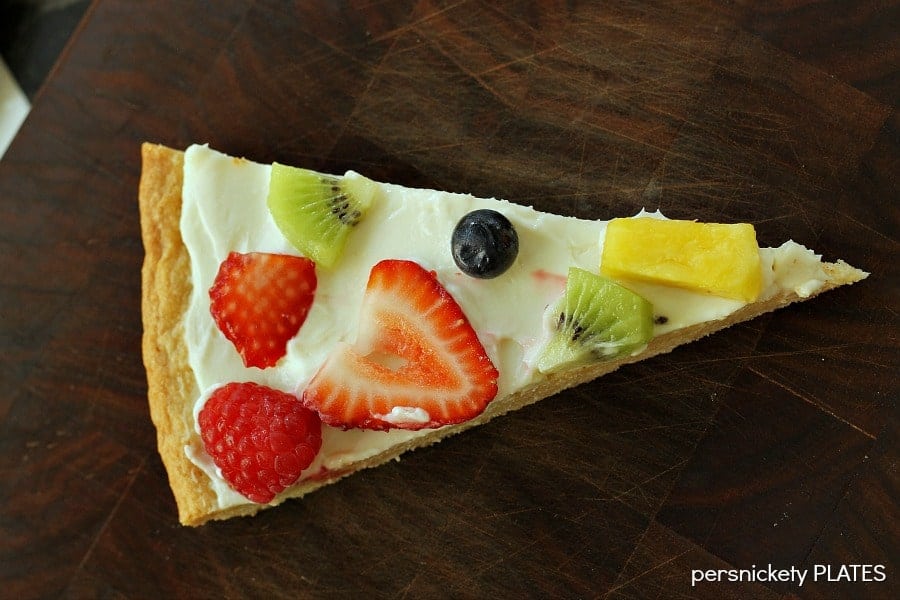 Sugar Cookie Fruit Pizza -a thin sugar cookie "crust" spread with a cream cheese "sauce" and topped with strawberries, raspberries, kiwi, blueberries, pineapple - whatever fruit you love!