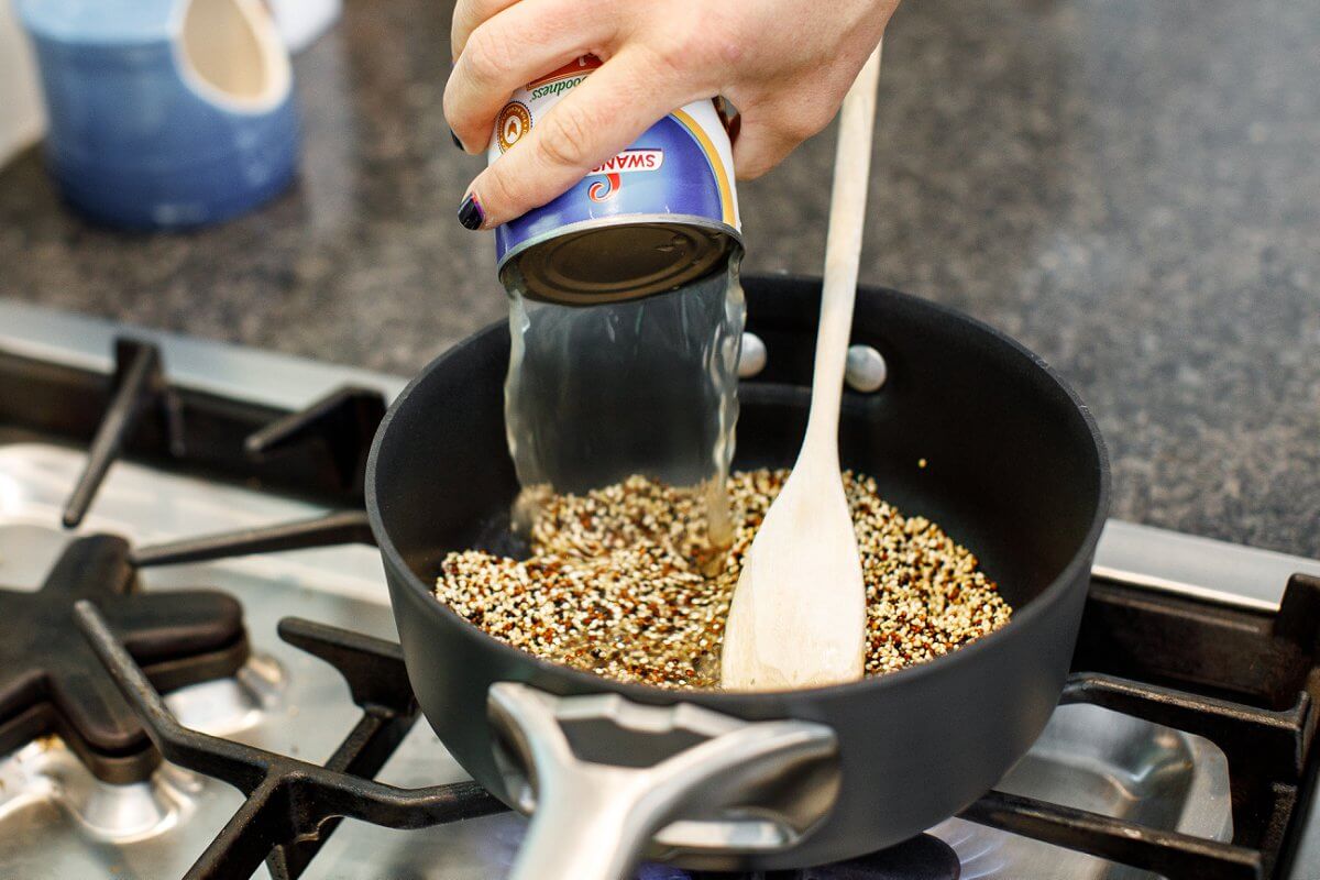 Liz pouring in chicken broth