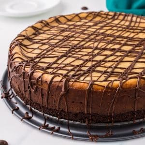 peanut butter brownie cheesecake drizzled with chocolate.