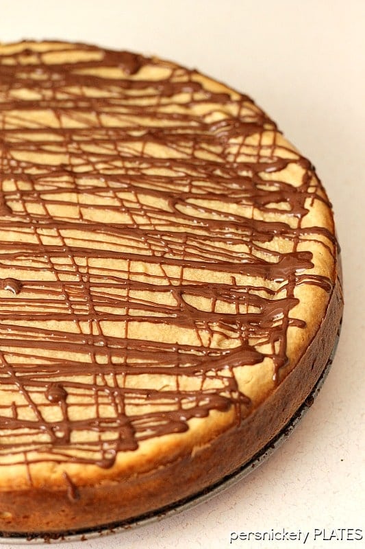 Brownie Bottom Peanut Butter Cheesecake has a layer of chewy brownie topped with a creamy peanut butter cheesecake and drizzled with rich chocolate. | www.persnicketyplates.com #cheesecake #peanutbutter #brownie #dessert