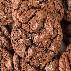 pile of fudgy brownie cookies topped with sea salt