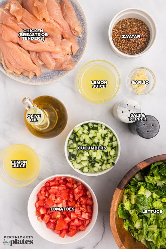 overhead shot of labeled ingredients laid out to make a salad with chicken.