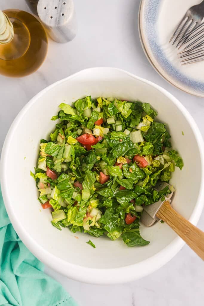 overhead shot of salad in a mixing bowl.