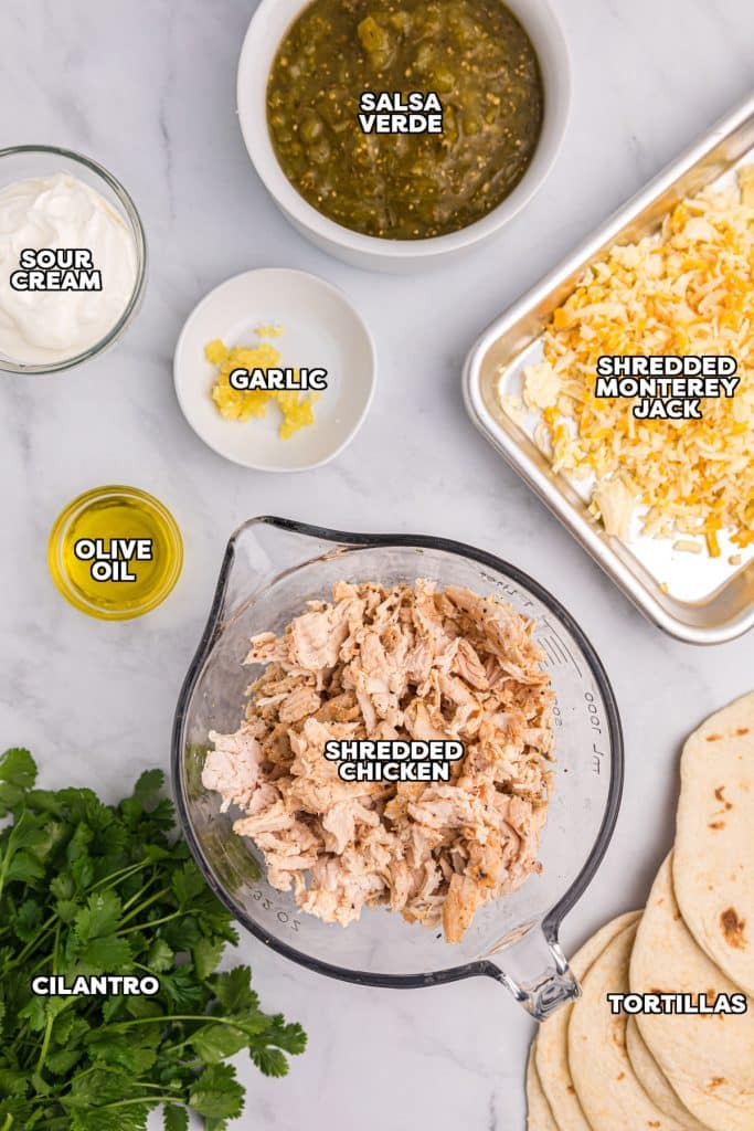 overhead shot of labeled ingredients laid out to make salsa verde chicken enchiladas.
