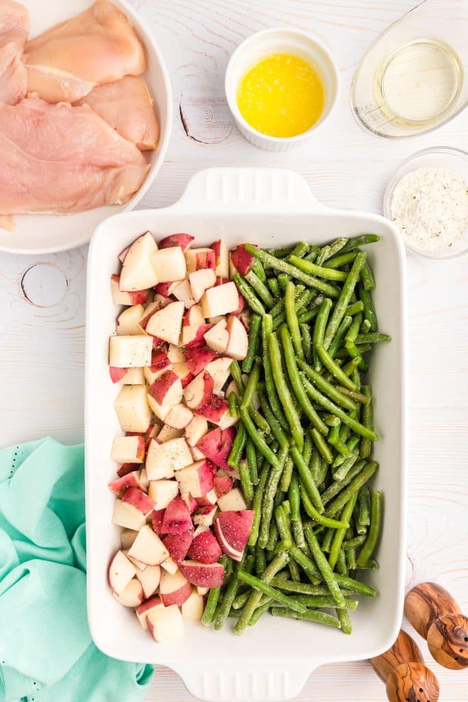 overhead shot of red skin potatoes & green beans in a baking dish.