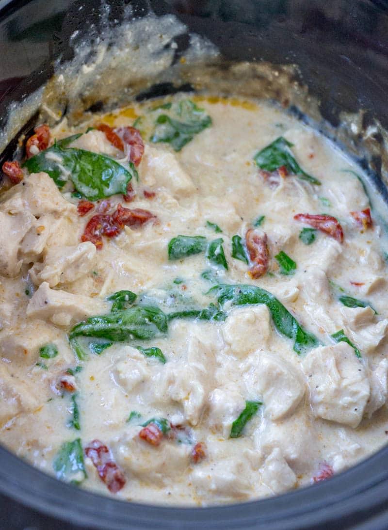 crock pot chicken alfredo in slow cooker bowl Five ingredient, super simple, Crock Pot Chicken Alfredo takes no time at all to throw together in the slow cooker. This easy crockpot chicken alfredo recipe will become a staple in your meal plan.