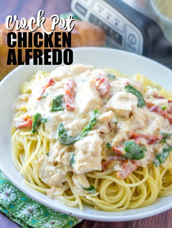 Five ingredient, super simple, Crock Pot Chicken Alfredo takes no time at all to throw together in the slow cooker. This easy crockpot chicken alfredo recipe will become a staple in your meal plan. large white bowl of crock pot chicken alfredo pasta