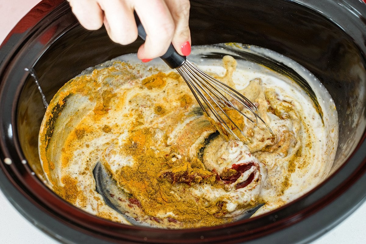 whisking indian butter chicken in crock pot