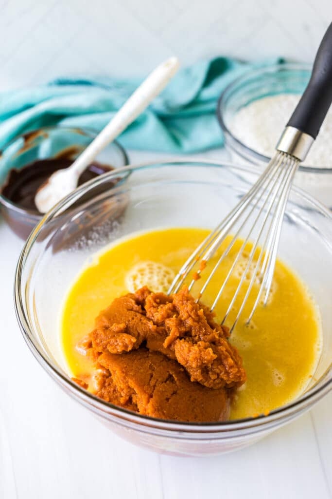 mixing bowl with whisk and pumpkin puree.