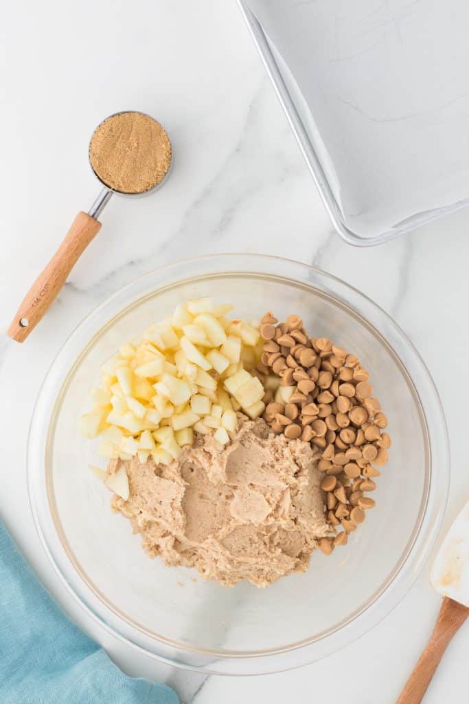 overhead shot of blondie batter and diced apples in a mixing bowl.