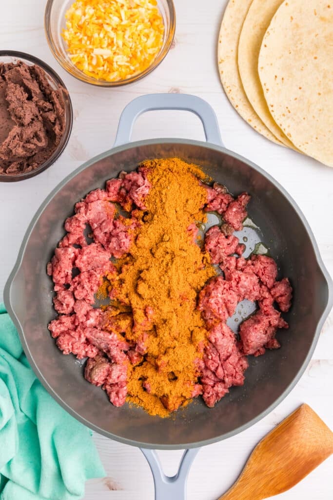 ground meat in a skillet with taco seasoning.