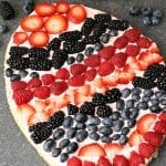 A festive Easter egg sugar cookie fruit "pizza" with strawberry cream cheese frosting. You can make it super simple with a sugar cookie mix or make it from scratch. | Persnickety Plates