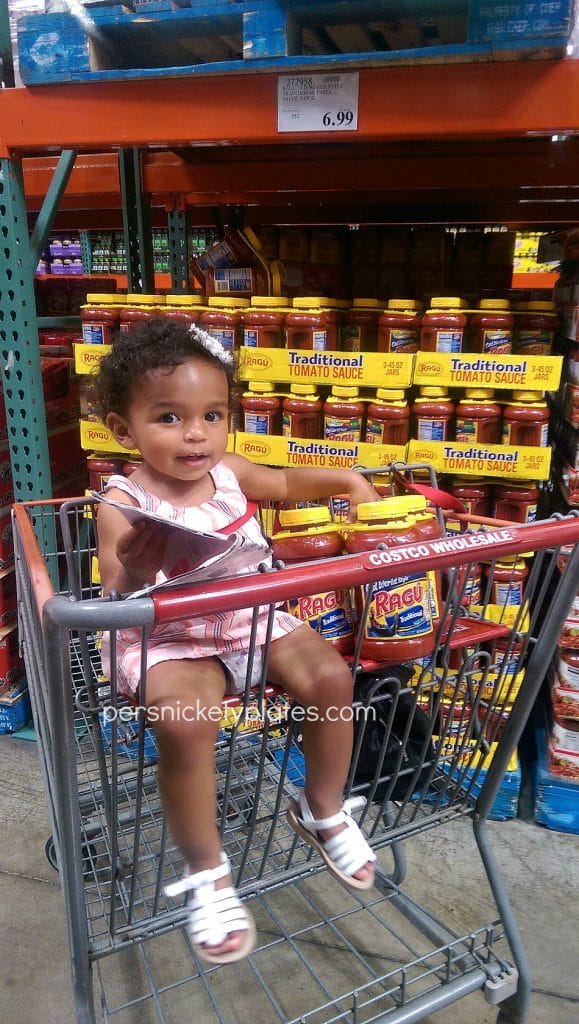 girl in costco shopping cart buying ragu sauce