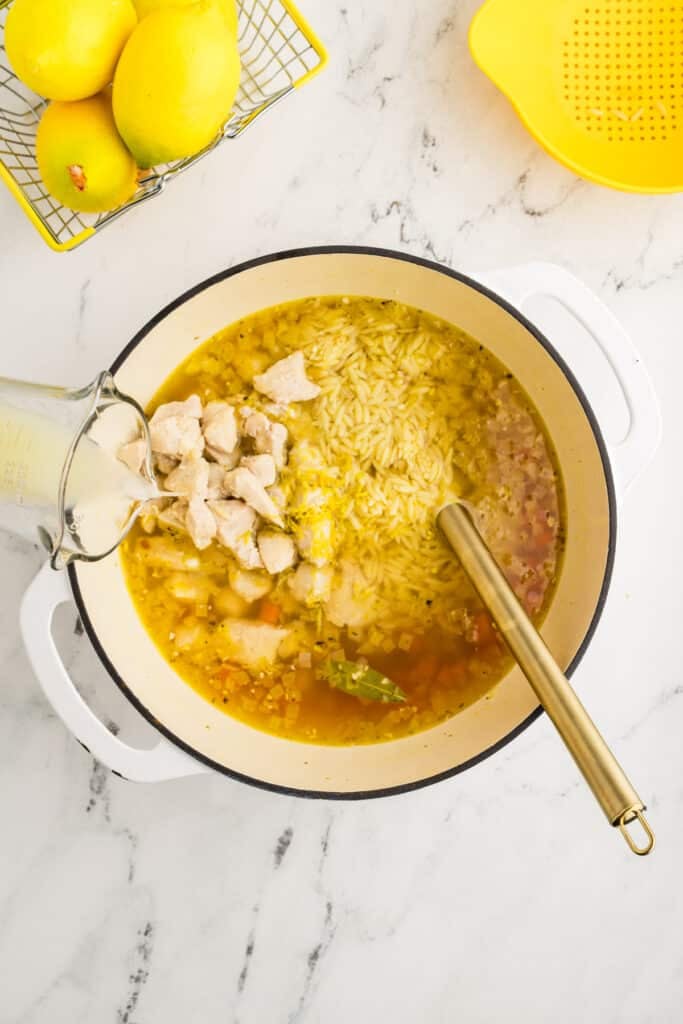 lemon juice pouring into a pot of soup.