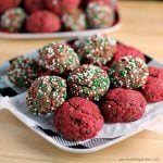 plate full of chocolate fudge cookie bites covered in christmas sprinkles