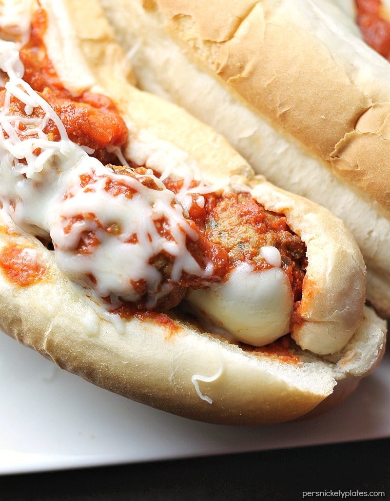 Easy Italian Chicken Meatball Subs smothered in a homemade marinara sauce and topped with provolone and mozzarella cheese! | Persnickety Plates