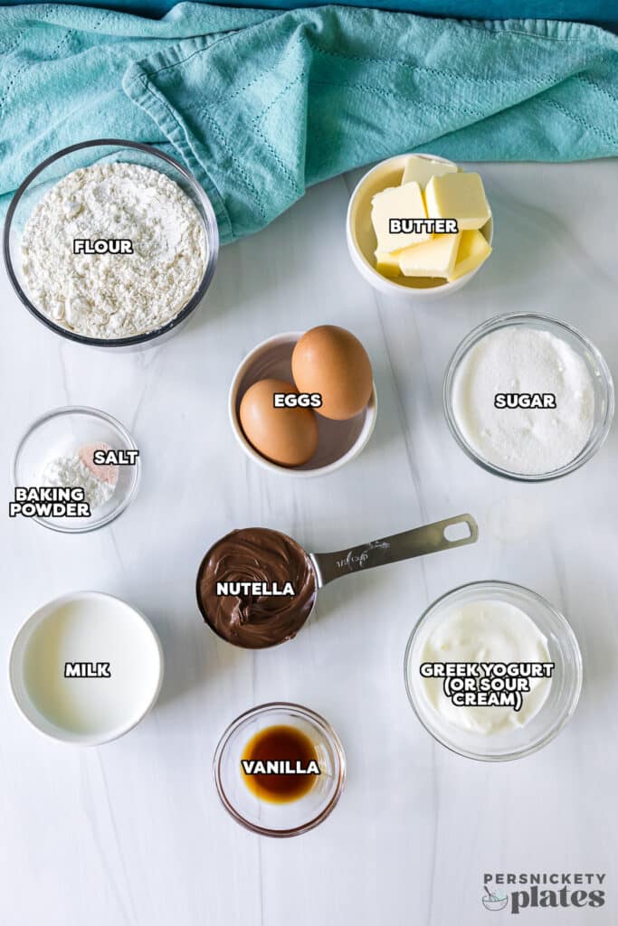 overhead shot of labeled ingredients laid out to make nutella muffins.